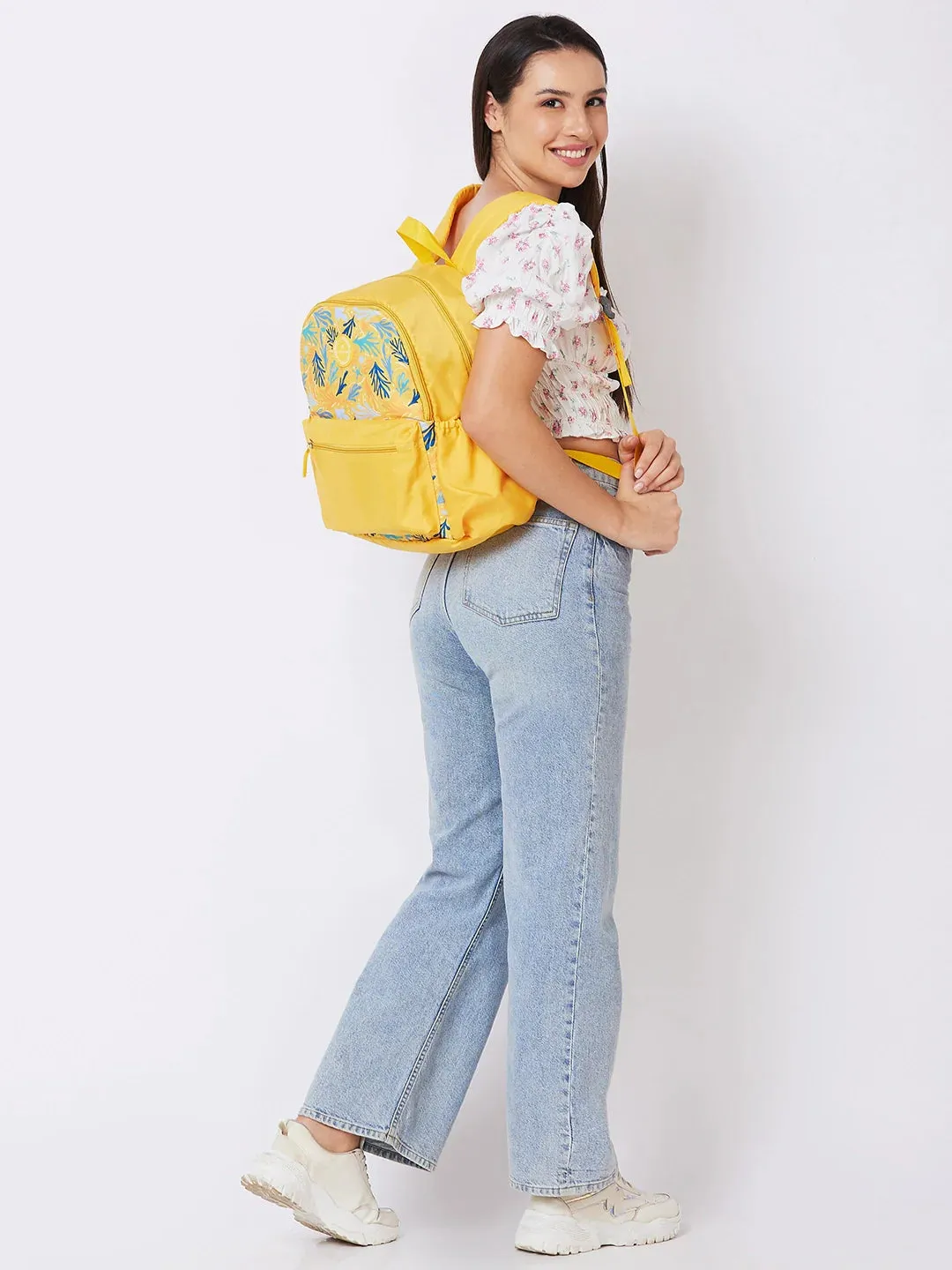 Caprese Xenia Medium Yellow Printed Backpack