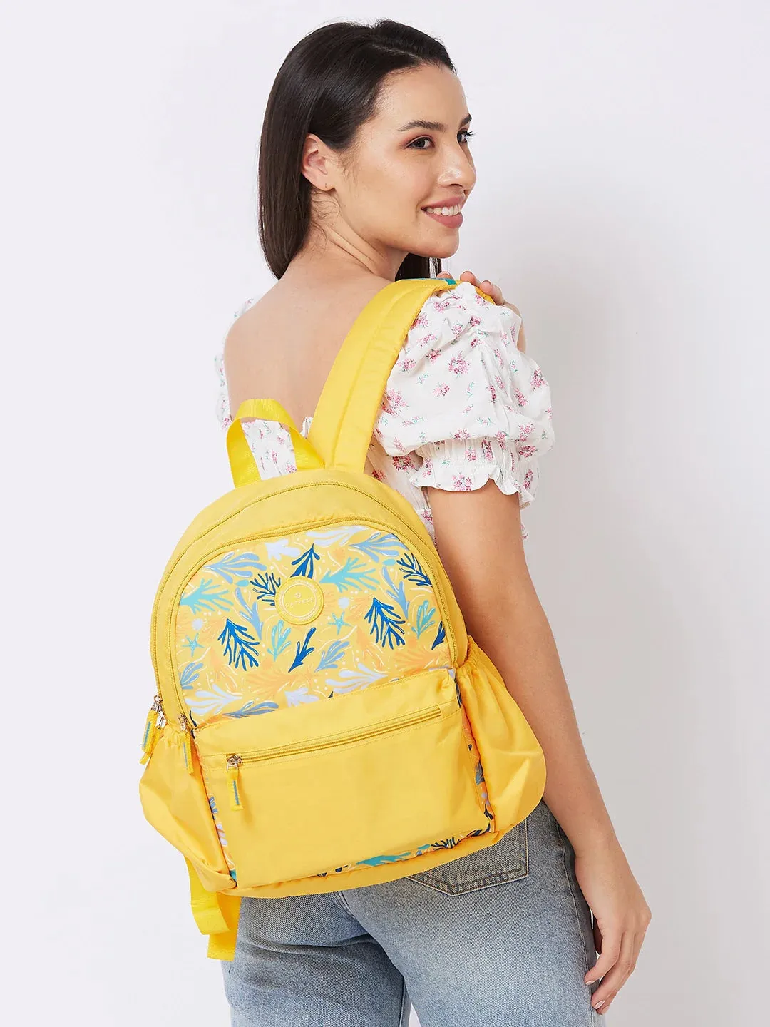 Caprese Xenia Medium Yellow Printed Backpack