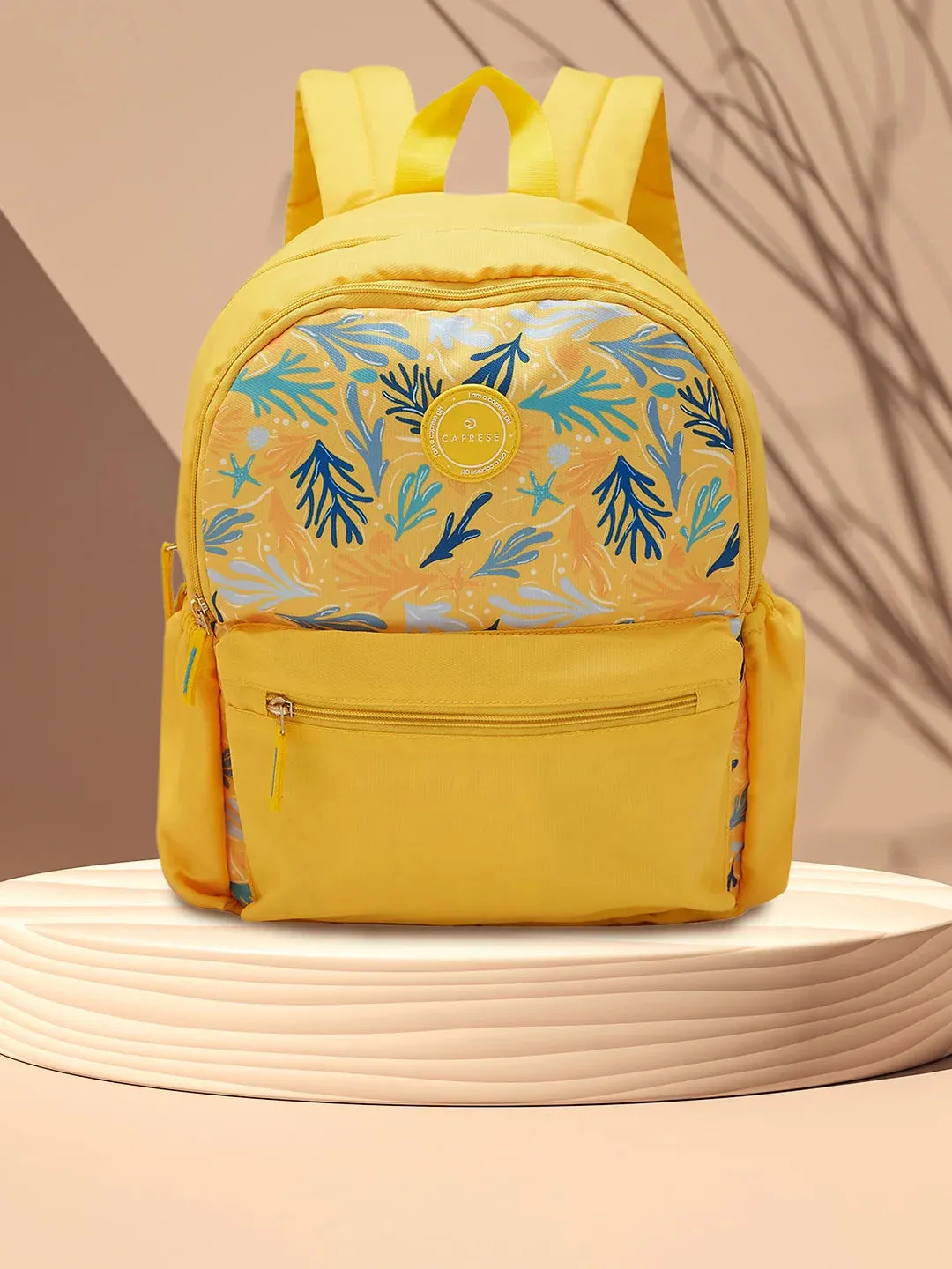 Caprese Xenia Medium Yellow Printed Backpack