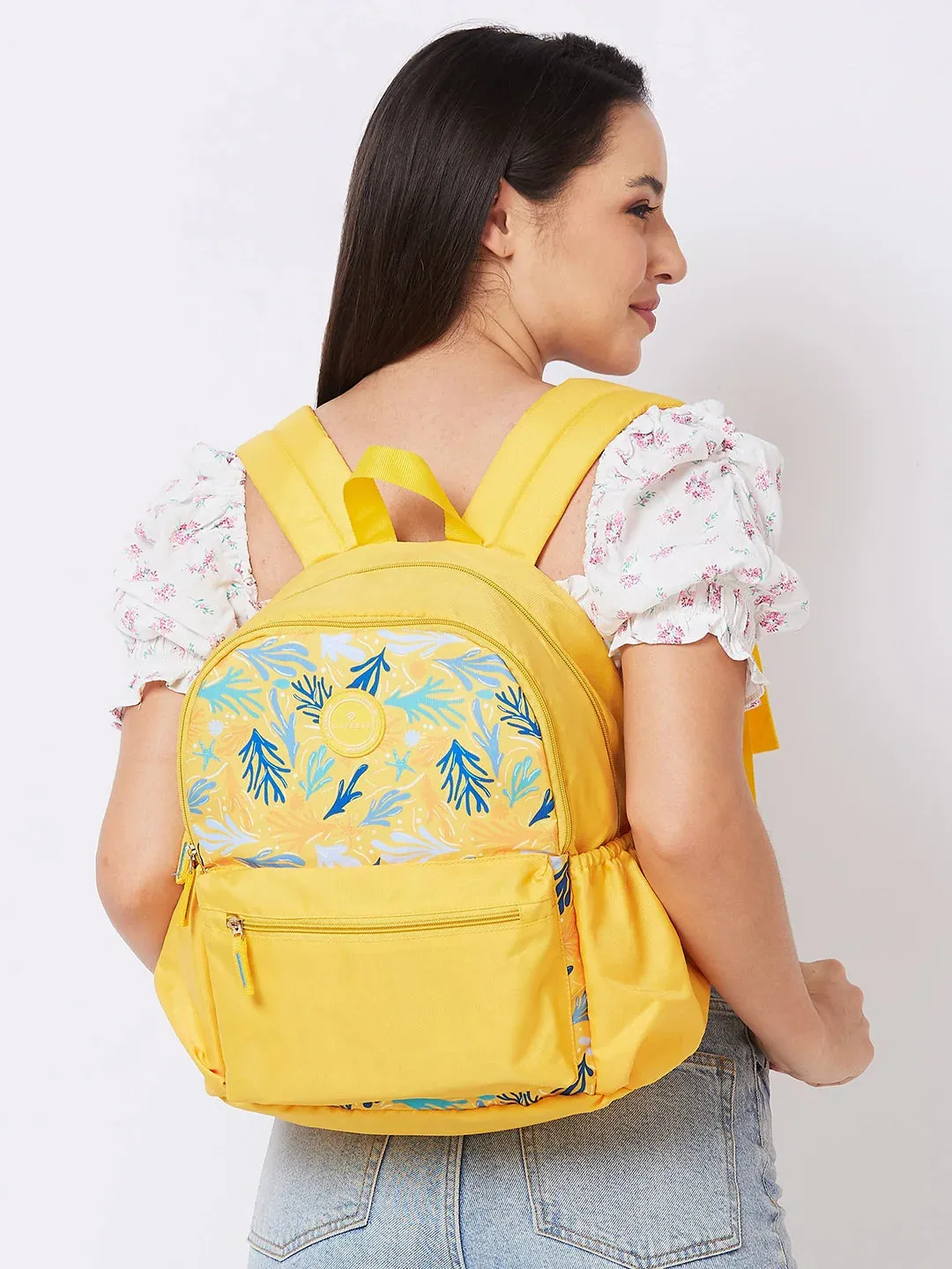 Caprese Xenia Medium Yellow Printed Backpack